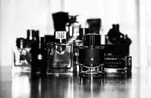 grayscale photo of perfume bottles